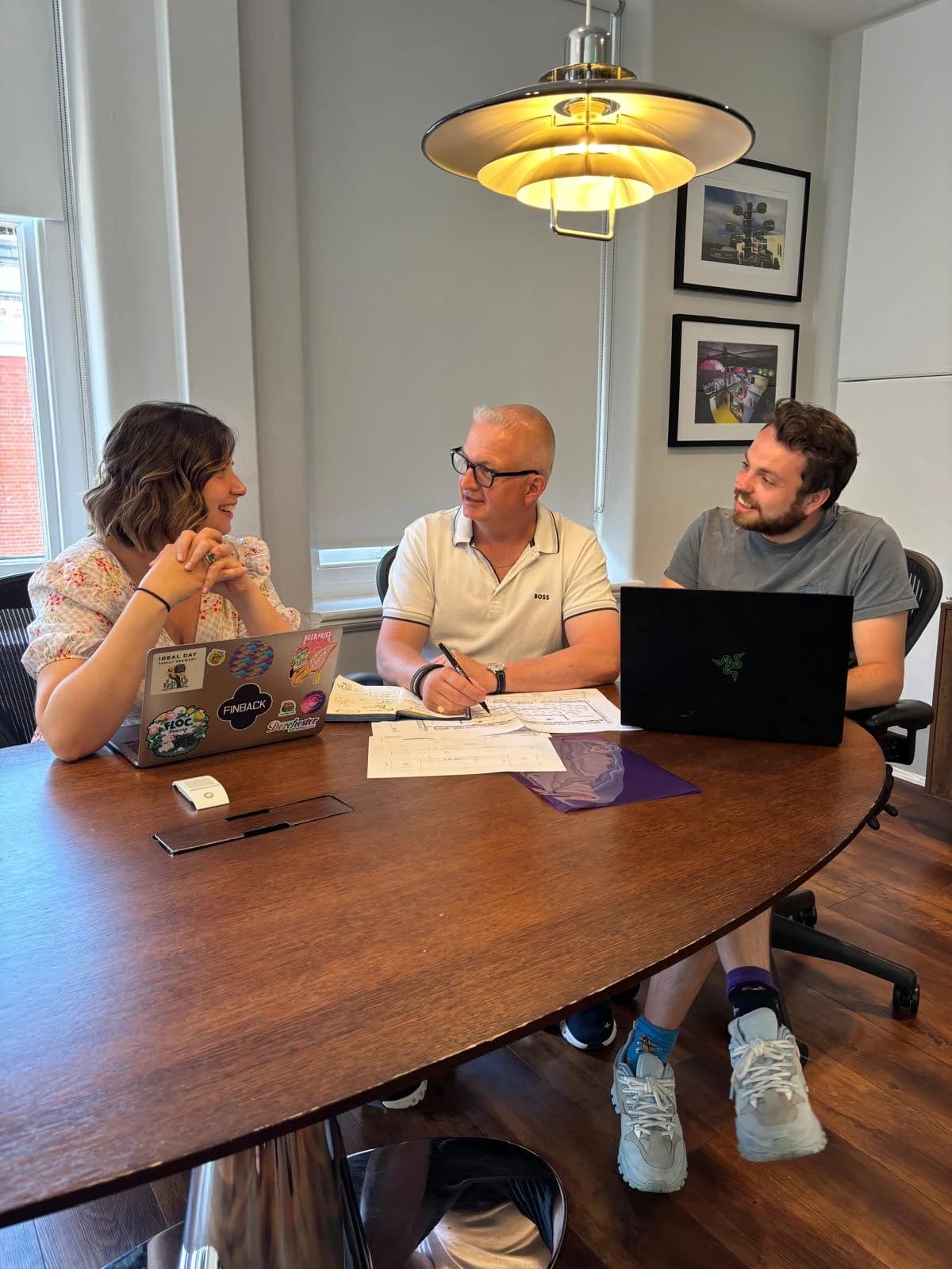 The DMS team discussing production plans around a table